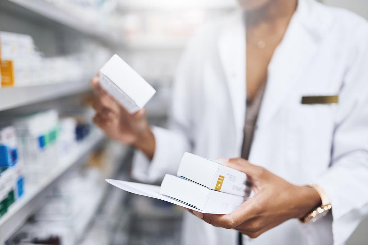 Pharmacist holding box of meds