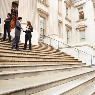 People standing on the steps of a government building