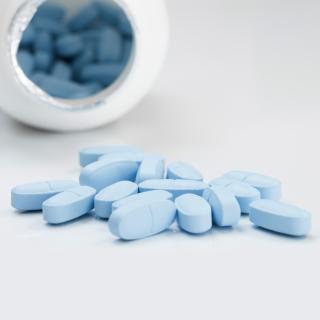 bottle tipped over with blue tablets